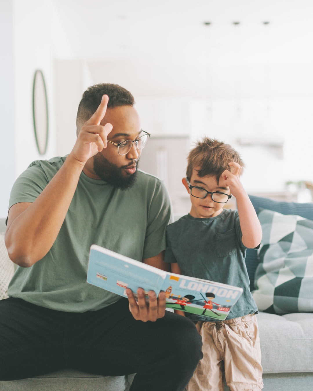 Der Therapeut und der junge Patient sitzen neben einander und trainieren Zeichensprache.